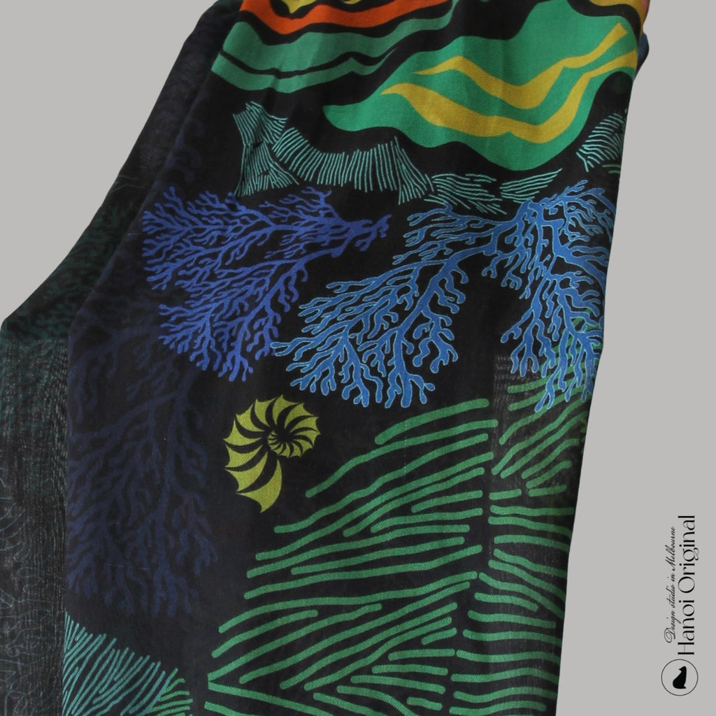 Colorful scarf with marine-themed design featuring corals and sea creatures on a gray background.