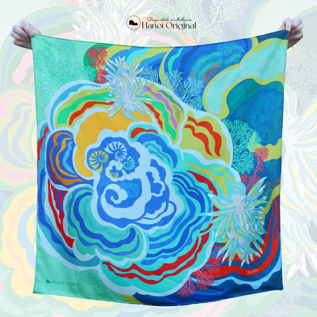 A square scarf by Hanoi Original studio, depicting ocean scape with seaslugs, coral reefs and fish by Hanoi Original studio