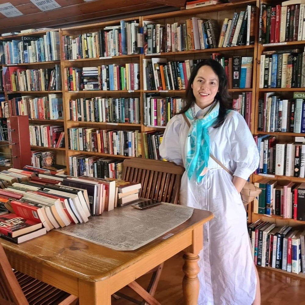 Hanoi Original Silk Scarf 90cm on white shirt dress, in a bookstore 